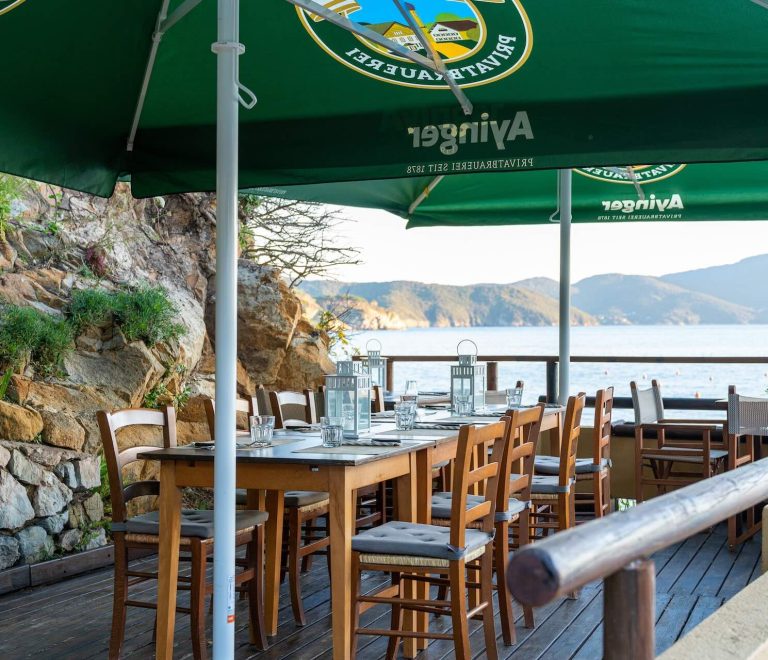 Terrazza dell’Osteria di Mare al Camping Enfola con tavoli all’aperto vista mare