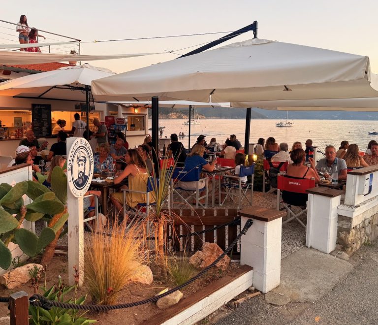 Emanuel Beach Bar a Enfola con tavoli sul mare e clienti al tramonto