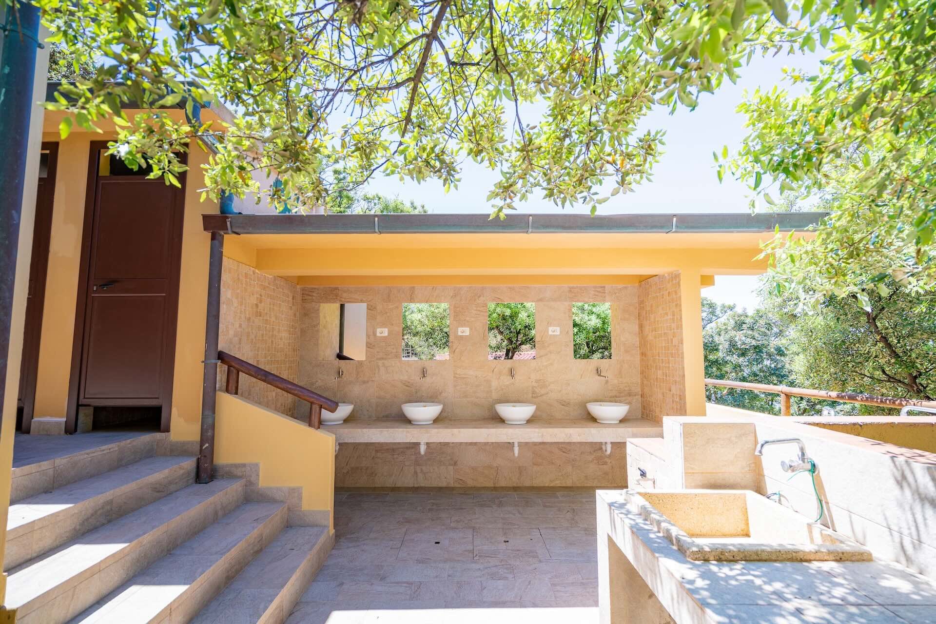 Lavabi dei servizi igienici comuni del Camping Enfola curati e luminosi